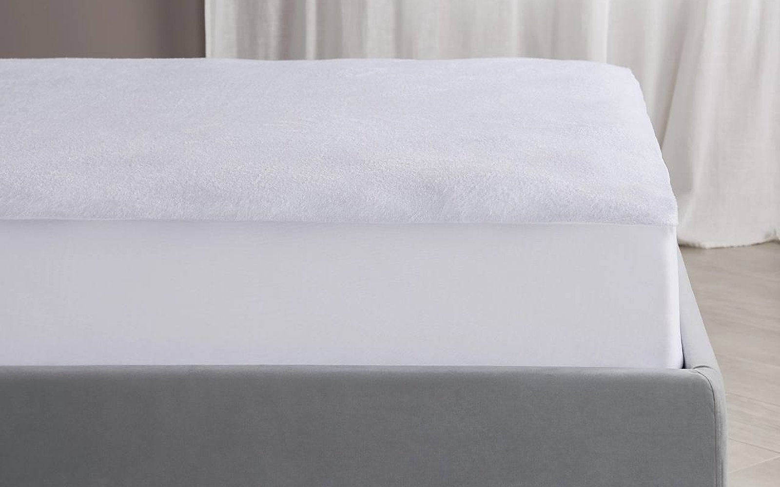 Terry mattress protector in a bedroom interior, view 1